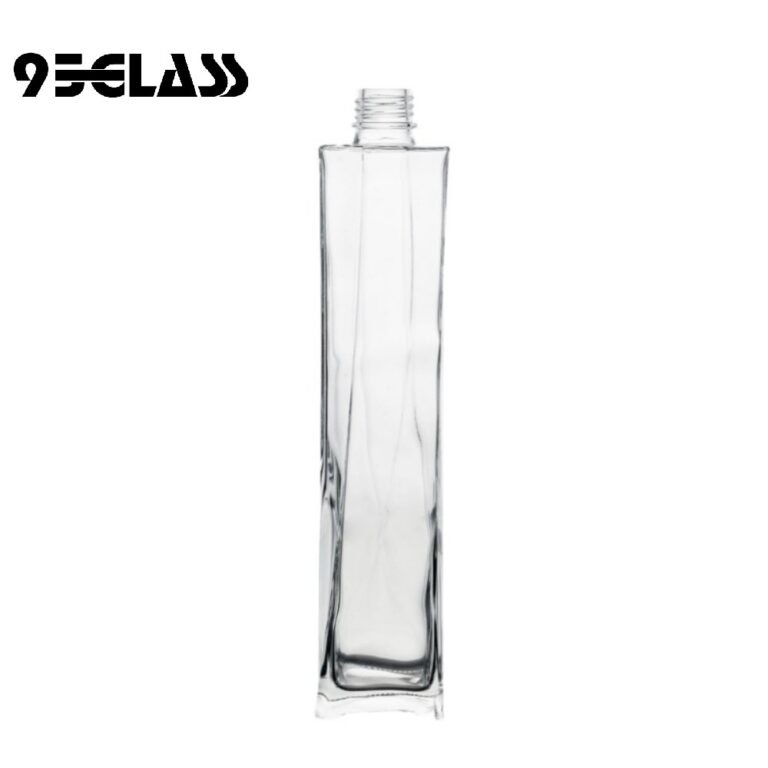 Tall crystal-clear square bottle whiskey with sleek vertical design for premium spirits.