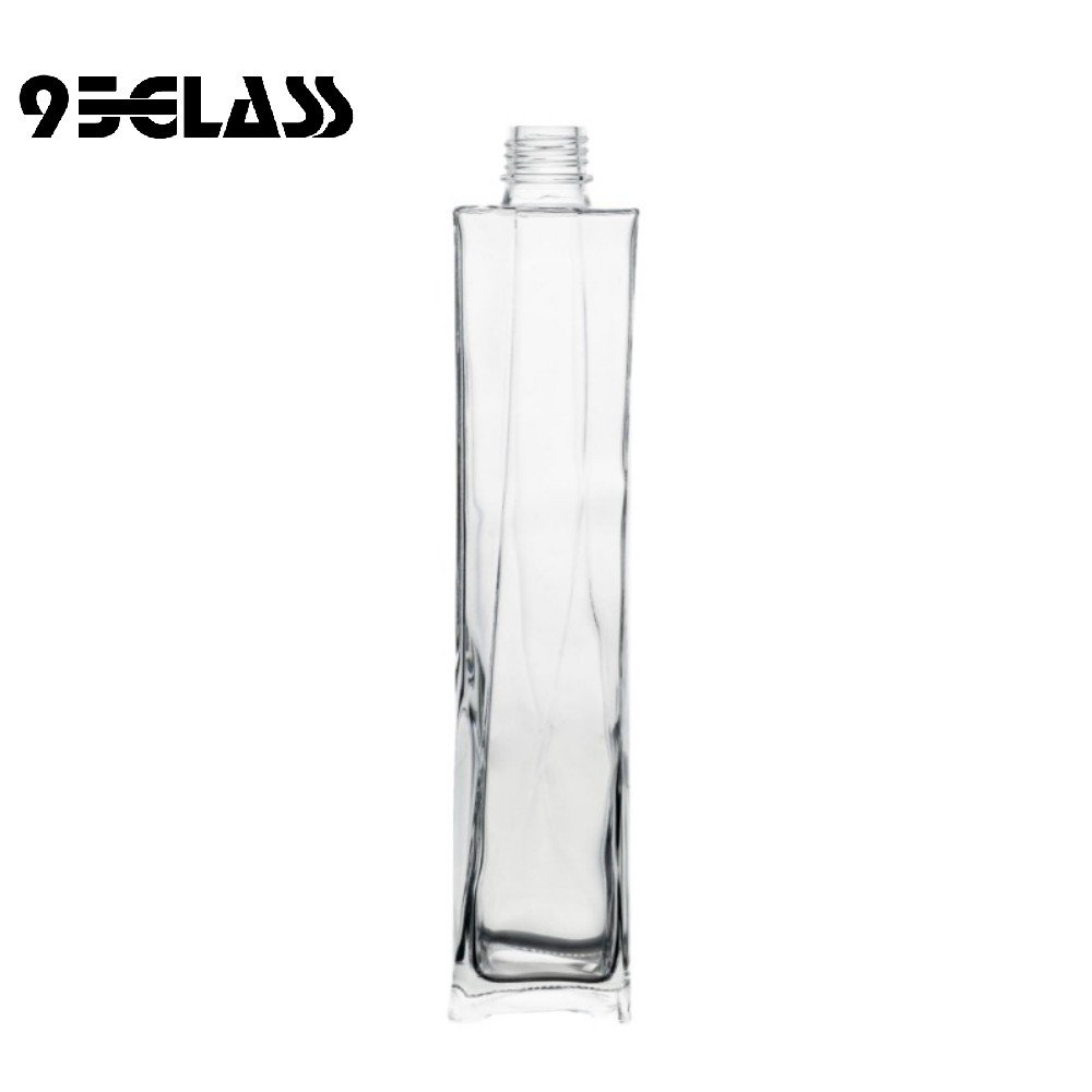 Tall crystal-clear square bottle whiskey with sleek vertical design for premium spirits.