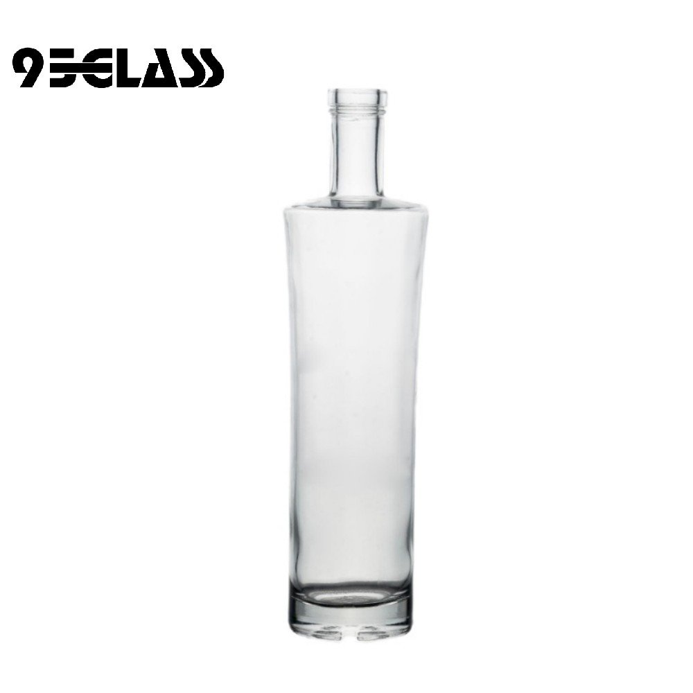 Tall crystal-clear straight glass liquor bottles for whiskey, vodka, and spirits.
