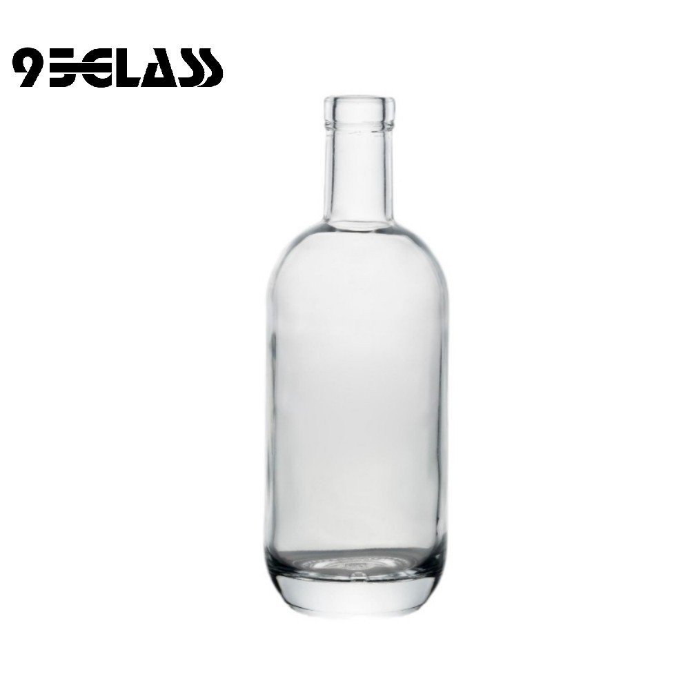 Classic round empty glass bottle with smooth shoulders and thick base for spirits.