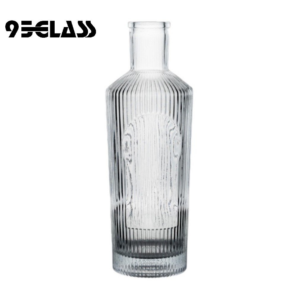 Vertical groove crystal-clear glass spirit bottle for sale with textured body and modern style.