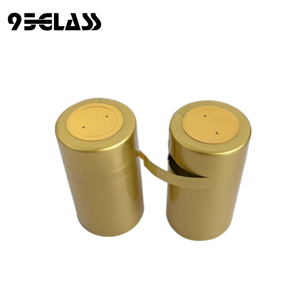 glossy gold tear-strip pvc capsule heat shrinker with round top disc and vent holes