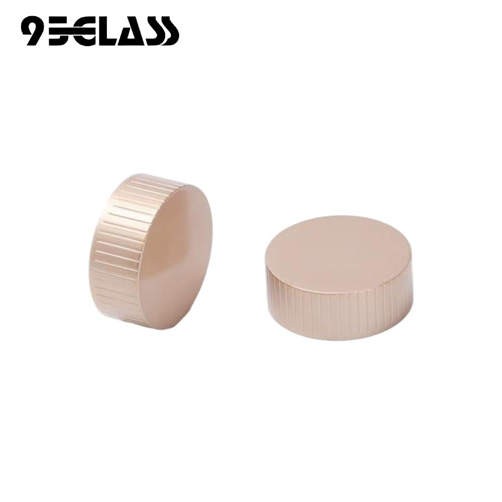 Champagne gold plastic screw cap with striped side for liquor bottles.